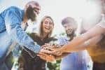 Multiracial happy young people stacking hands on top of each other – Diverse friends unity togetherness in volunteer community – Concept about college, relationship, youth and human resources